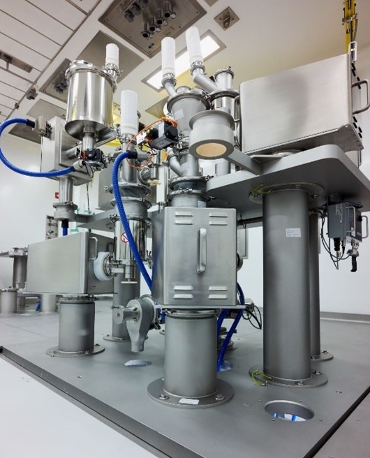 Upper level of continuous manufacturing process train: Feeder table consisting of six loss-in-weight feeders, a co-mill, and a continuous blender